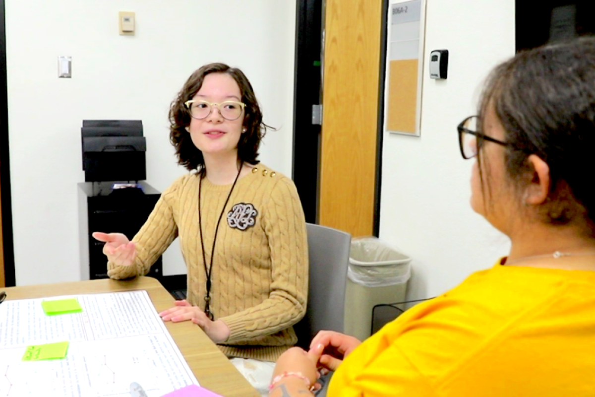 Abigail discusses course work with a fellow student Chrystal Vazquez.