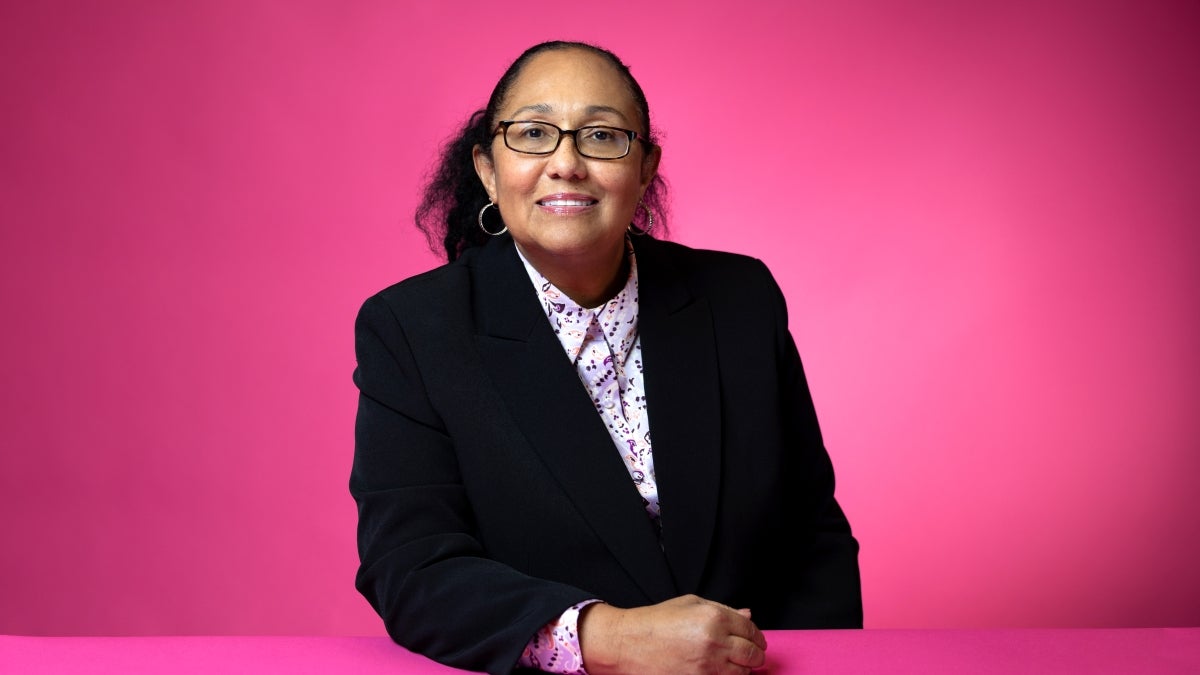 Maria Cruz-Torres photographed in front of pink background at ASU