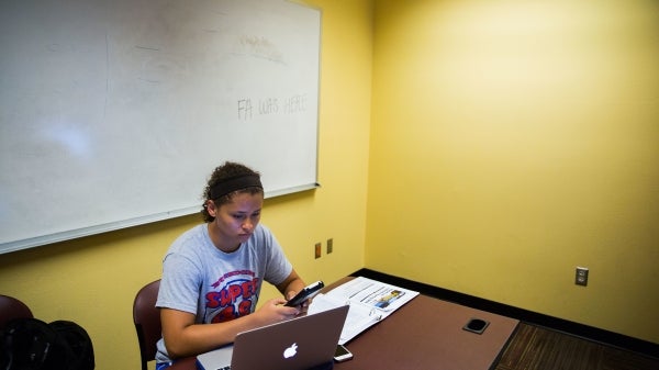 woman in study hall working on computer
