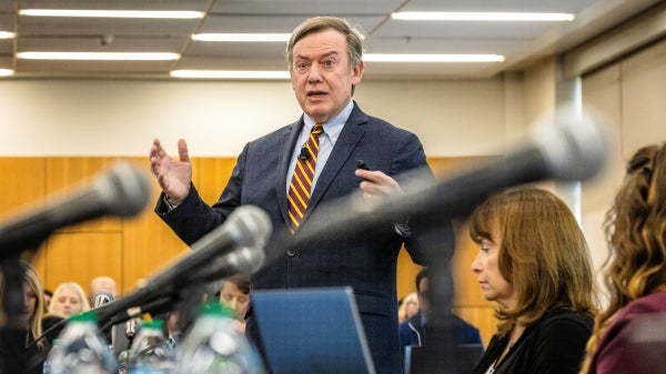 ASU President Michael Crow speaks in front of a room of people