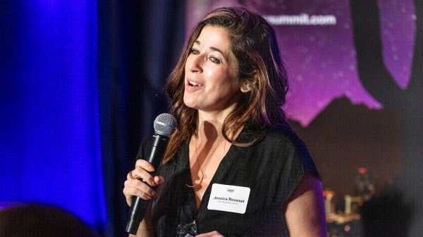 Woman speaks into a microphone