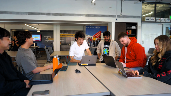 A group of college students around a table at the DASSH 2025 Design Challenge at ASU