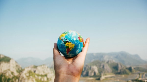 Hand holding a small globe