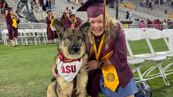 Suzette May and her German shepherd Seeing Eye Dog, Fred, attend Arizona State University’s graduation ceremony. 
