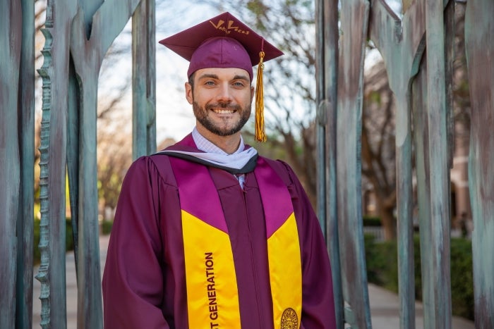 Travis Harrick smiles for the camera in front of the Paley Gates.